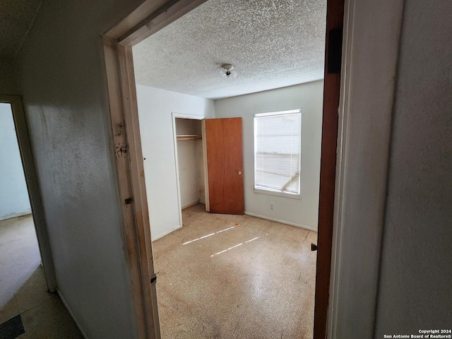 unfurnished bedroom with a textured ceiling