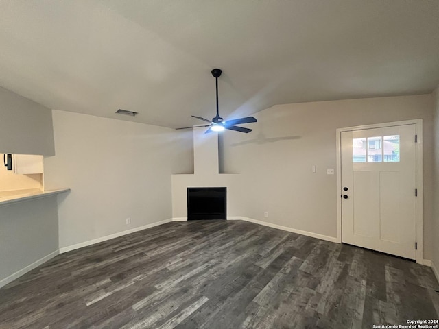 unfurnished living room featuring ceiling fan, lofted ceiling, and dark wood-type flooring