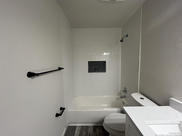 full bathroom with vanity, toilet, tiled shower / bath, and hardwood / wood-style flooring