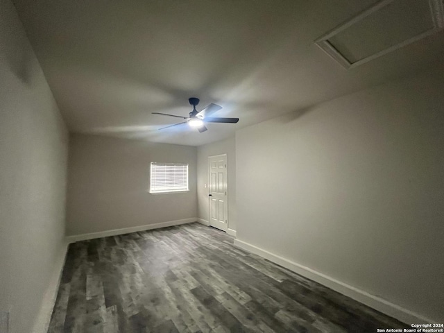 spare room with ceiling fan and dark hardwood / wood-style flooring