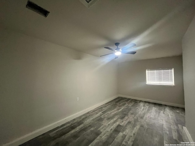 empty room with dark hardwood / wood-style floors and ceiling fan