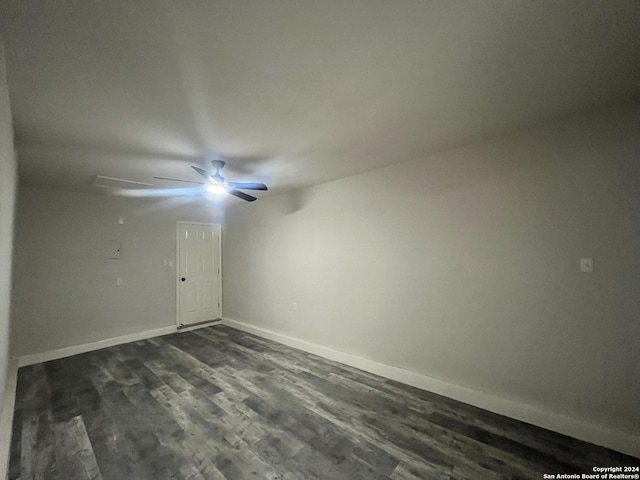 empty room with ceiling fan and dark wood-type flooring