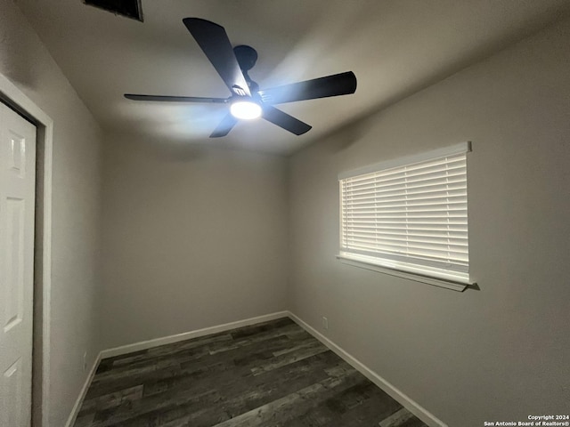 empty room featuring dark hardwood / wood-style floors and ceiling fan