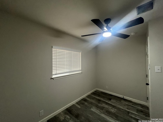 spare room with dark hardwood / wood-style flooring and ceiling fan