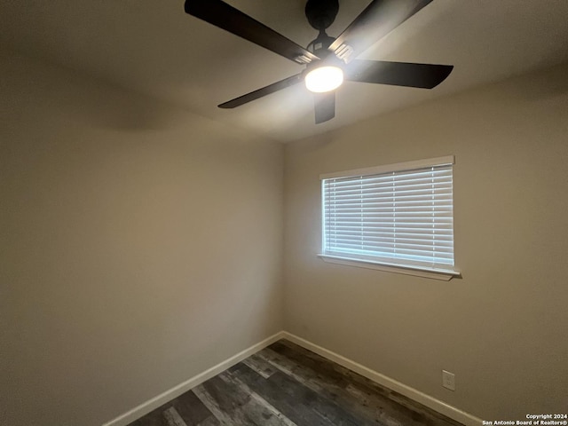 empty room featuring ceiling fan and dark hardwood / wood-style flooring