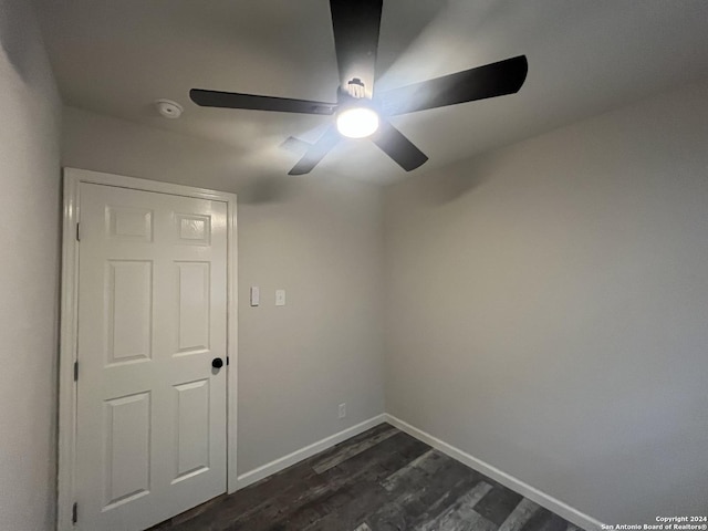 spare room with ceiling fan and dark wood-type flooring