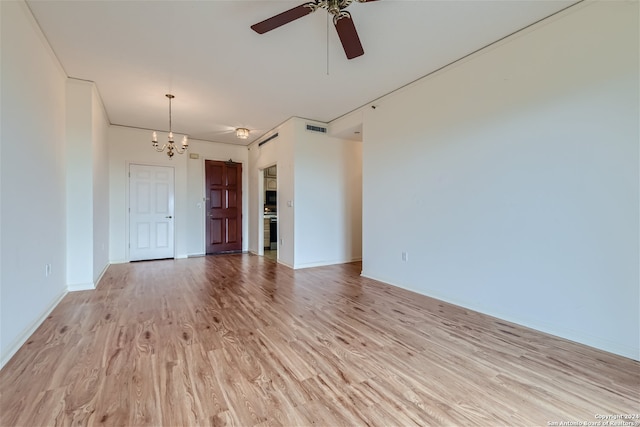 unfurnished living room featuring ceiling fan with notable chandelier and light wood-type flooring