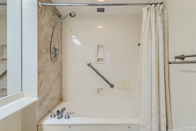 bathroom with shower / bathtub combination with curtain