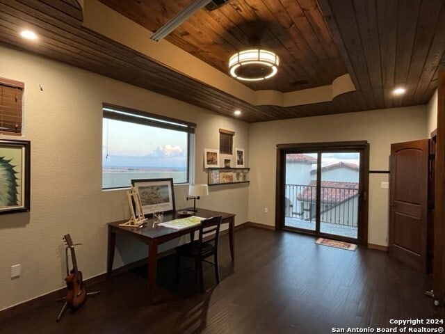 office area featuring dark hardwood / wood-style flooring, a raised ceiling, and wood ceiling