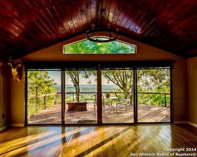 entryway with wood ceiling, wood-type flooring, and lofted ceiling