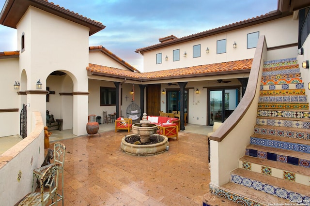 back of house featuring ceiling fan, a patio, and an outdoor living space