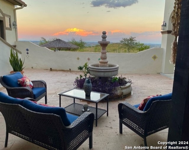 patio terrace at dusk with an outdoor living space