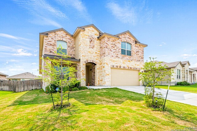 view of front of property with a garage and a front lawn