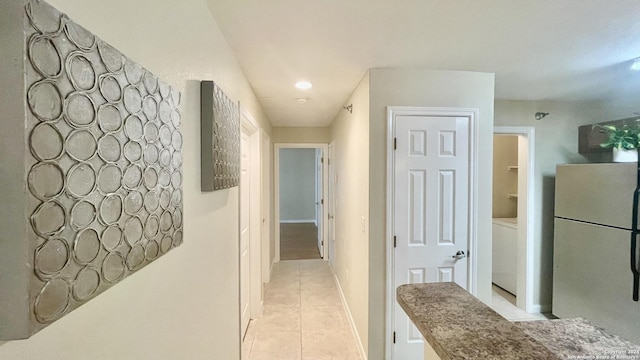 hallway featuring light tile patterned floors