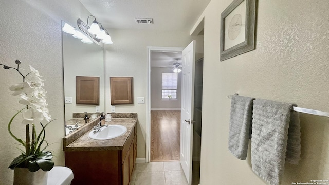 bathroom with hardwood / wood-style floors, vanity, and a textured ceiling