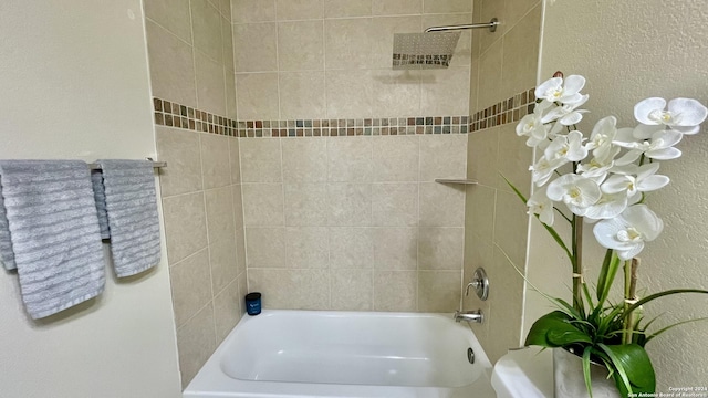 bathroom featuring tiled shower / bath