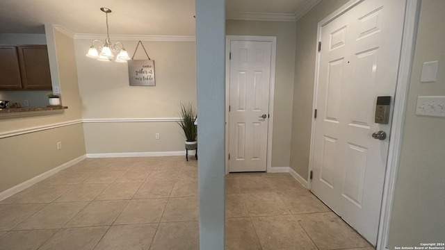 interior space featuring crown molding, light tile patterned floors, and an inviting chandelier