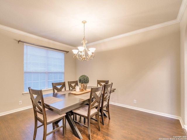 dining space with dark hardwood / wood-style floors, ornamental molding, and a chandelier