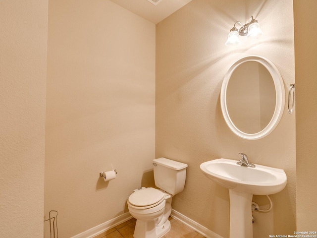 bathroom with tile patterned flooring, toilet, and sink