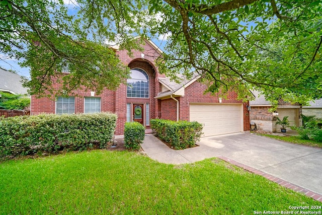 view of front of home with a front lawn and a garage