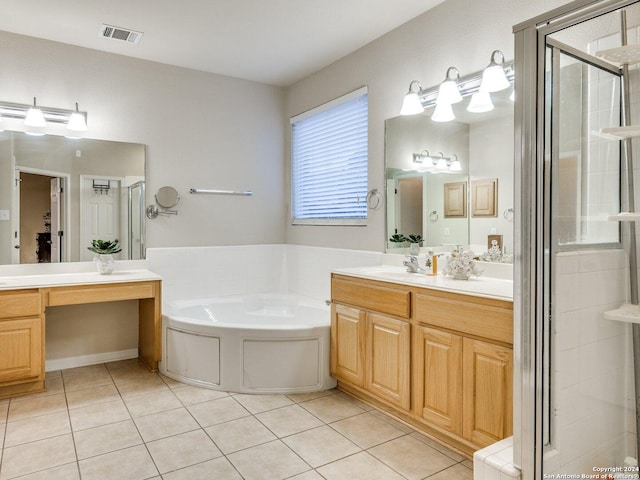 bathroom with tile patterned flooring, vanity, and separate shower and tub