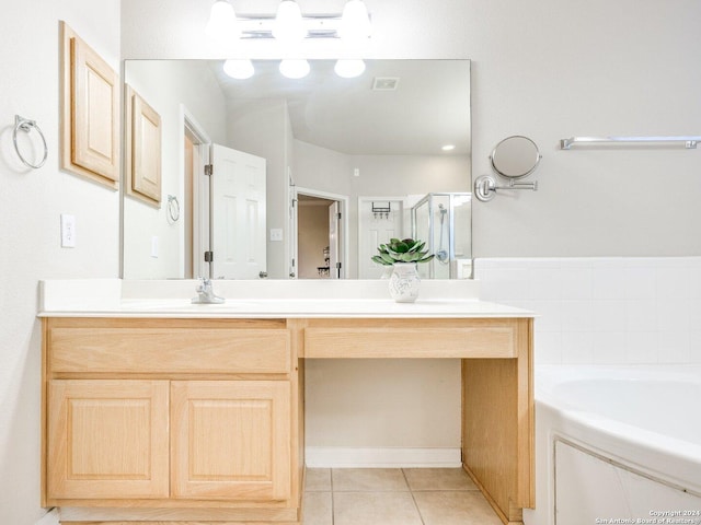 bathroom with plus walk in shower, vanity, and tile patterned floors