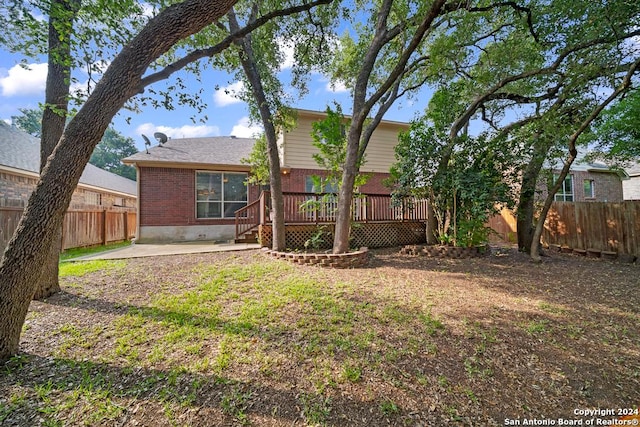 back of house with a patio area and a wooden deck