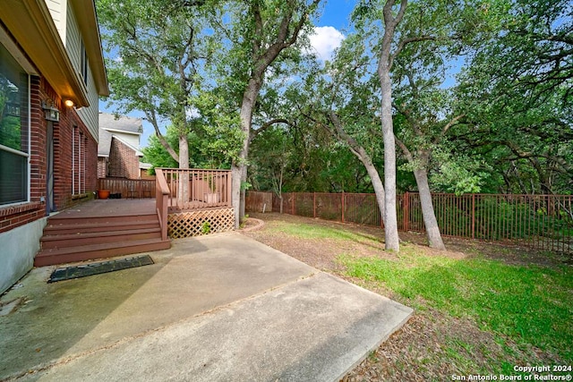 view of yard with a deck and a patio