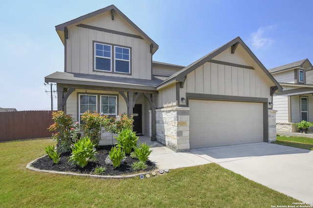 view of front of property featuring a front yard and a garage