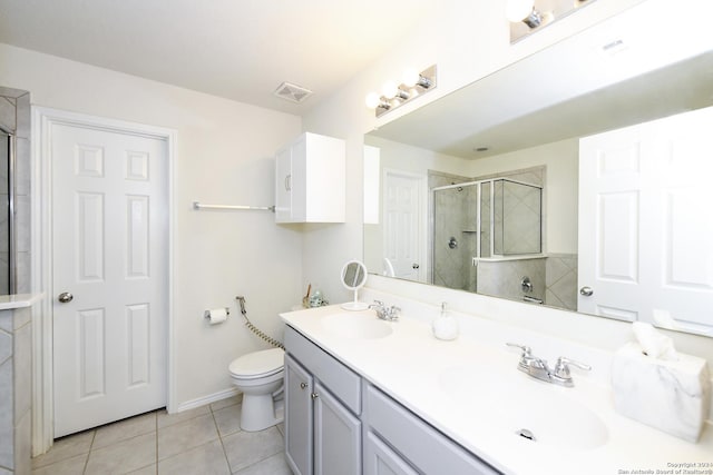 bathroom featuring tile patterned flooring, vanity, an enclosed shower, and toilet