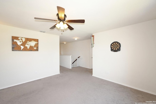 spare room with light colored carpet and ceiling fan