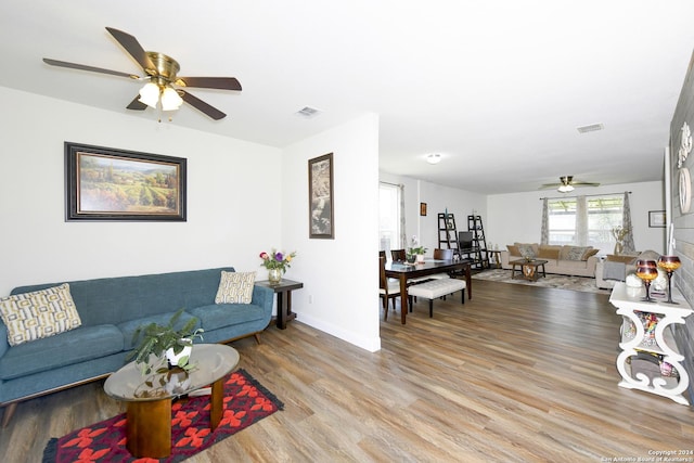 living room with ceiling fan and light wood-type flooring