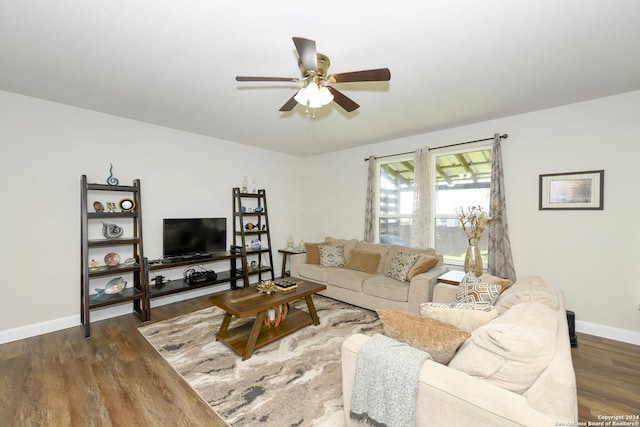 living room with ceiling fan and dark wood-type flooring