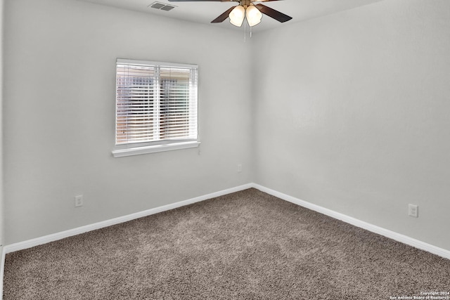 carpeted spare room with ceiling fan