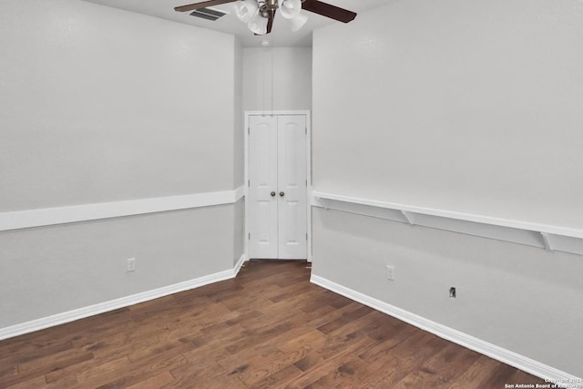 empty room featuring ceiling fan and dark hardwood / wood-style flooring