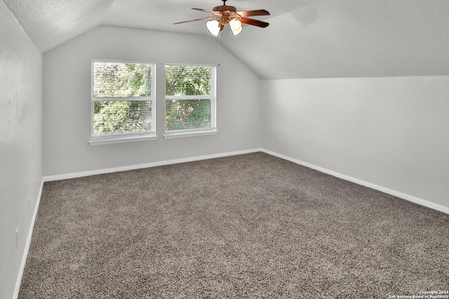 bonus room featuring a textured ceiling, ceiling fan, carpet floors, and lofted ceiling