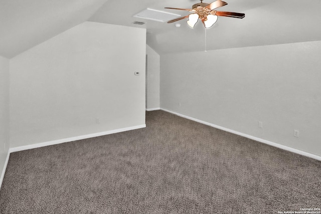 additional living space featuring dark carpet, ceiling fan, and lofted ceiling