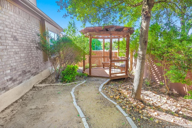 view of yard featuring a pergola and a deck