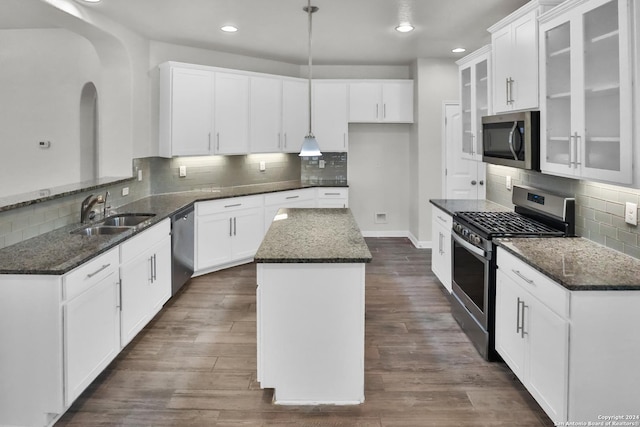 kitchen with a kitchen island, sink, white cabinetry, and stainless steel appliances