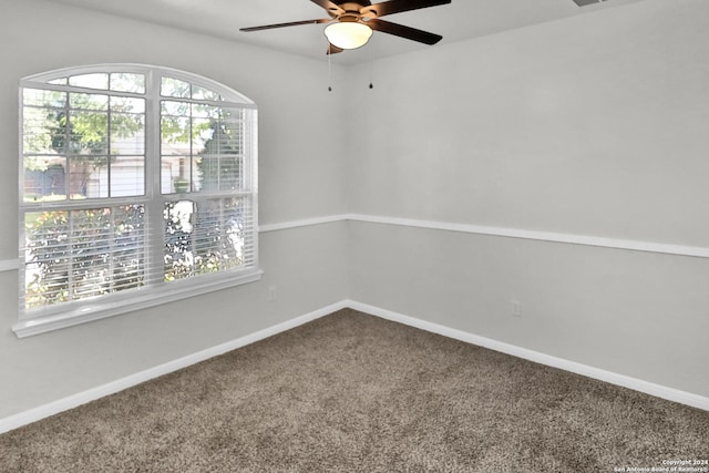 empty room featuring carpet floors and ceiling fan