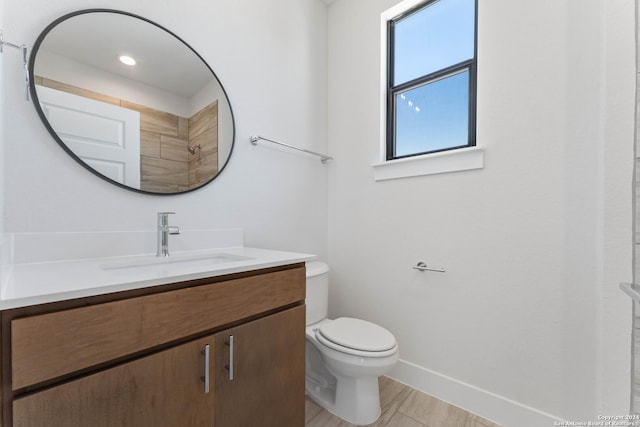 bathroom with hardwood / wood-style floors, vanity, and toilet