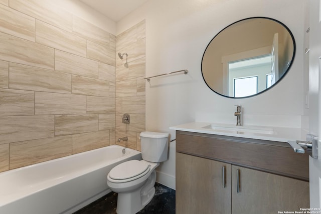 full bathroom featuring vanity, tiled shower / bath combo, and toilet