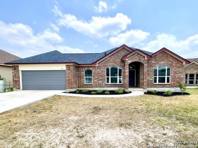 view of front of property featuring a garage and a front yard