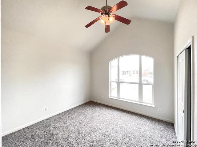 interior space featuring high vaulted ceiling and ceiling fan