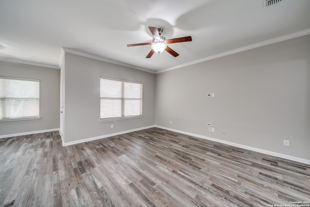 unfurnished room featuring crown molding, a healthy amount of sunlight, hardwood / wood-style floors, and ceiling fan