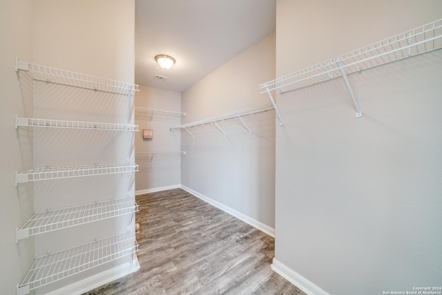 spacious closet with hardwood / wood-style flooring