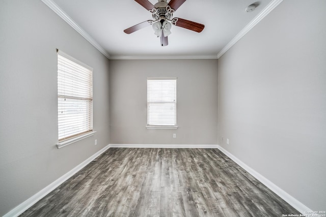 empty room with dark hardwood / wood-style flooring, crown molding, plenty of natural light, and ceiling fan