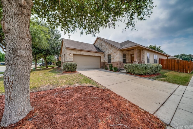 ranch-style home with a garage and a front lawn