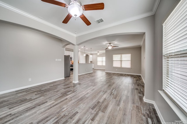 unfurnished living room featuring ceiling fan, ornamental molding, and hardwood / wood-style floors