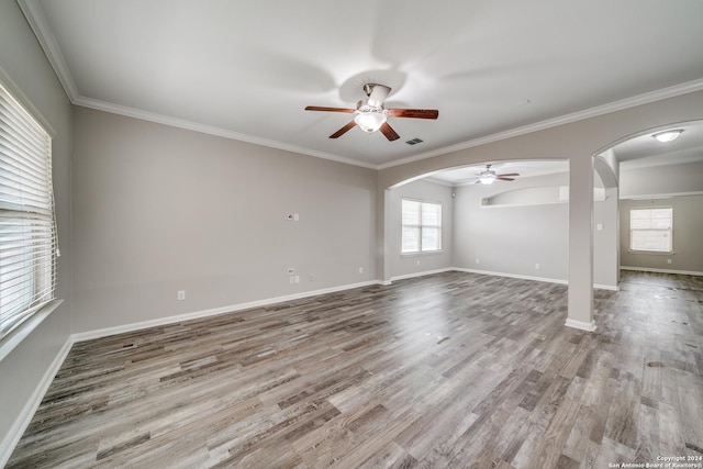 spare room featuring ornamental molding, ceiling fan, and light wood-type flooring